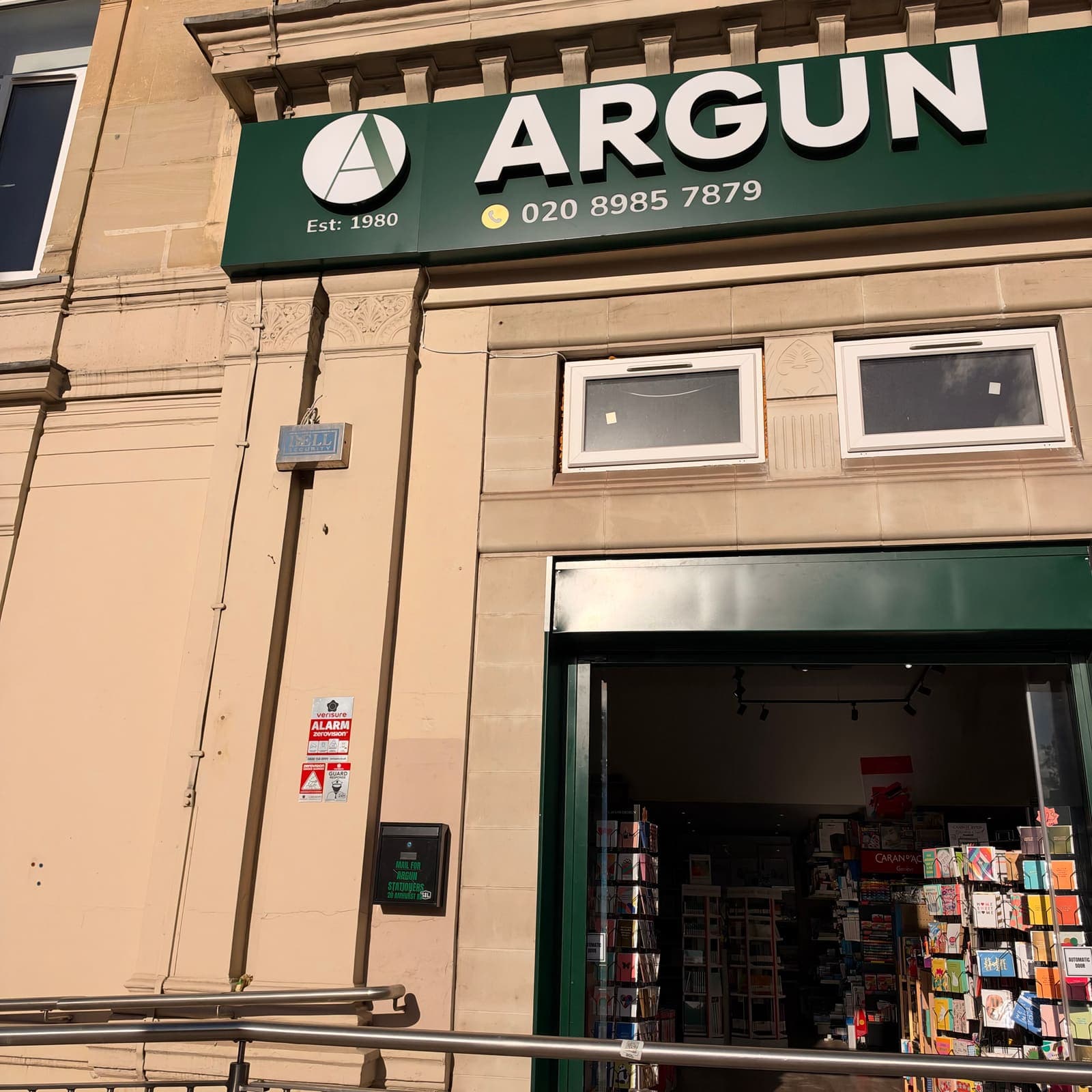 The Argun shopfront on Amhurst Road: a green sign reading ARGUN, Est. 1980, above the open door, with greetings cards and art materials inside.