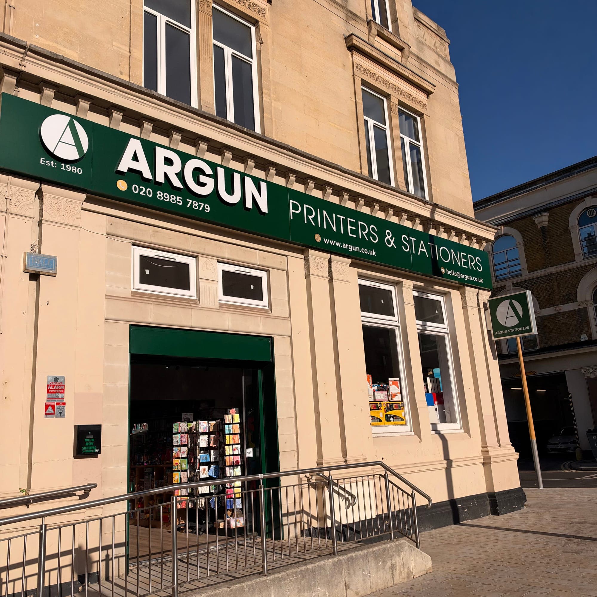 The Argun shop on Amhurst Road: a green fascia reading Argun Printers & Stationers, Est 1980, above an open door